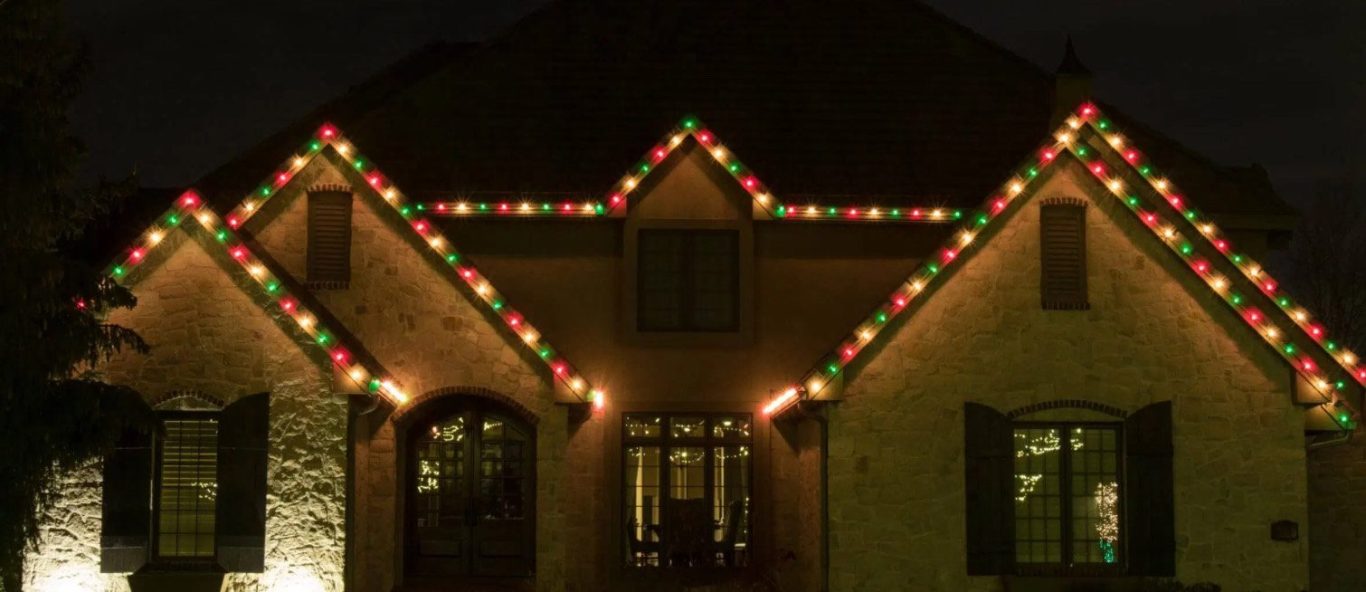 professional Christmas light installation red, white, and green on a home in Pinehurst TX